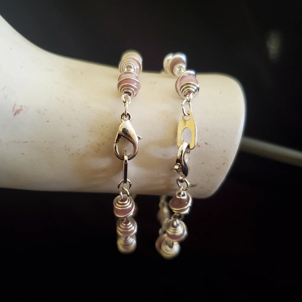 Two silver with pink pearl stones